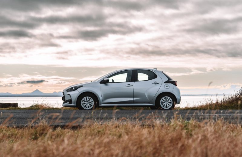 Toyota Yaris automatic compact rental car parked by the coast in Iceland